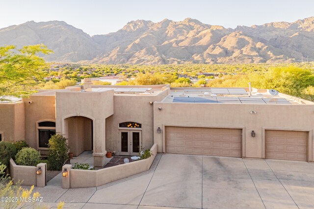 5327 N Ventana Overlook Pl, Tucson, AZ 85750 - view of front facade with a mountain view, stucco siding, french doors, and driveway