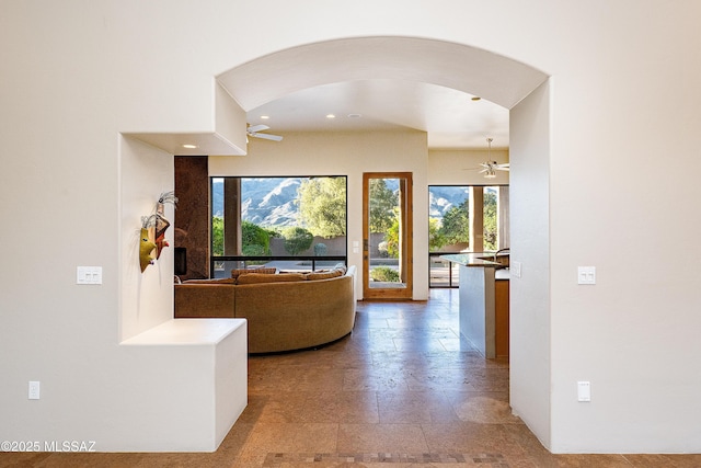 5327 N Ventana Overlook Pl, Tucson, AZ 85750 - hall featuring stone tile flooring, arched walkways, a healthy amount of sunlight, and recessed lighting