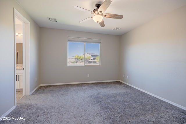 unfurnished room featuring ceiling fan, light colored carpet, baseboards, and visible vents