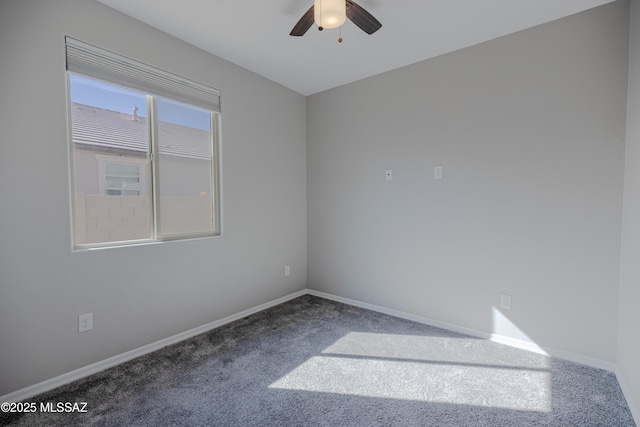 empty room with baseboards, a ceiling fan, and carpet