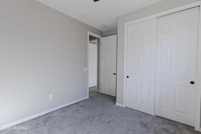 unfurnished bedroom with a closet, baseboards, carpet flooring, and visible vents