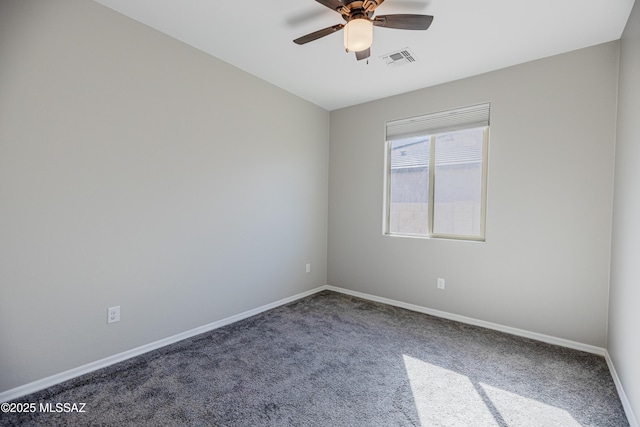 carpeted spare room featuring baseboards, ceiling fan, and visible vents