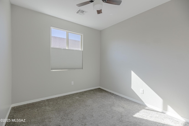 spare room with visible vents, a ceiling fan, baseboards, and carpet floors