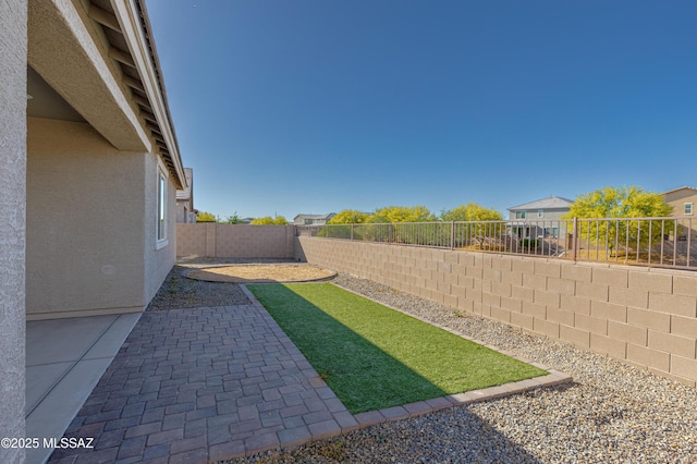 view of yard featuring a fenced backyard and a patio area
