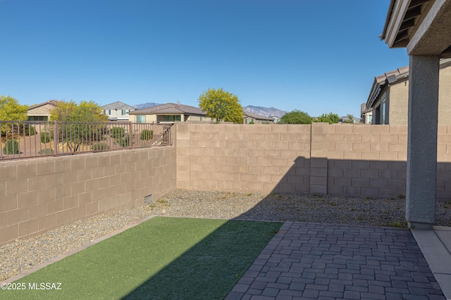 view of yard with a fenced backyard, a patio area, and a residential view