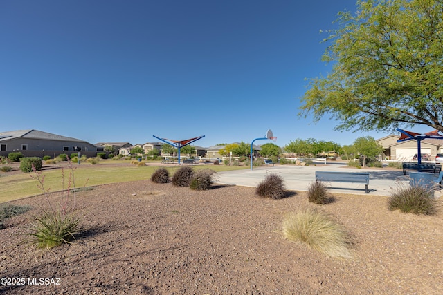 view of yard with community basketball court and a residential view