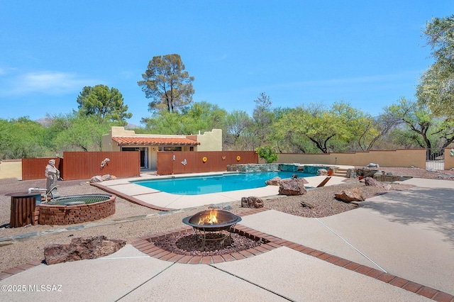view of swimming pool with a patio, a fire pit, a fenced backyard, and a fenced in pool