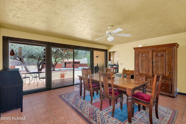 dining space with a textured ceiling, ceiling fan, and light tile patterned flooring
