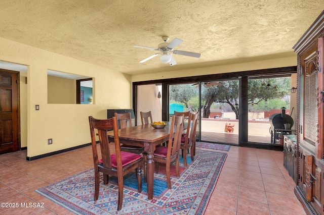 dining room with light tile patterned flooring, a textured ceiling, and plenty of natural light