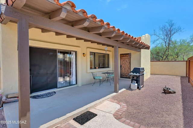view of patio / terrace with grilling area and fence