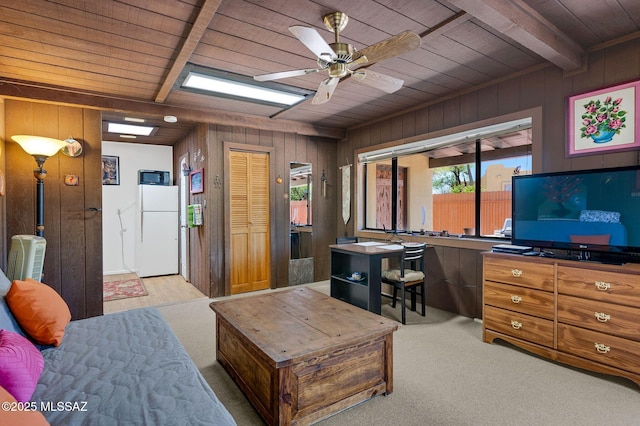 carpeted living room with wooden walls and wooden ceiling