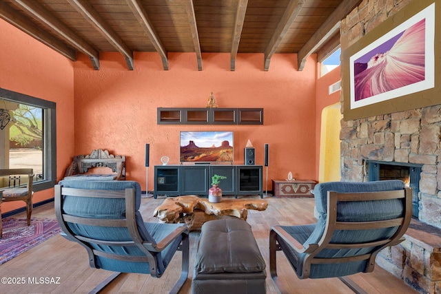 living area with wood ceiling, wood finished floors, and beamed ceiling