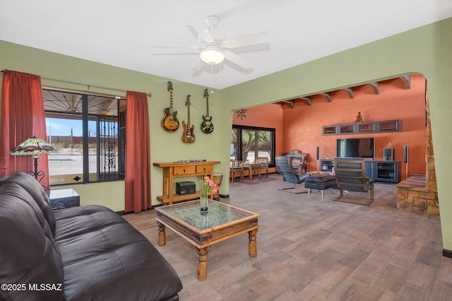 living area with ceiling fan and wood finished floors