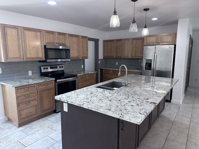 419 N Miller Ln, Saint David, AZ 85630 - kitchen with a sink, decorative backsplash, brown cabinets, pendant lighting, and stainless steel appliances