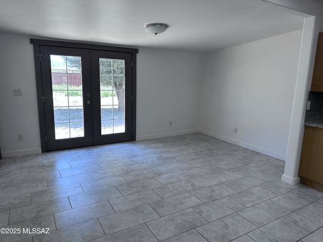 419 N Miller Ln, Saint David, AZ 85630 - unfurnished room with baseboards, light tile patterned flooring, and french doors