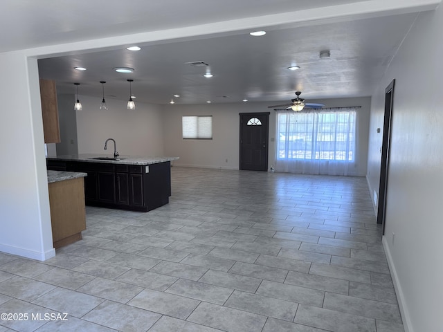 419 N Miller Ln, Saint David, AZ 85630 - kitchen with open floor plan, baseboards, a sink, and ceiling fan