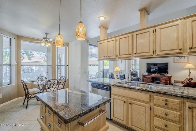 kitchen featuring a sink, dishwasher, a wealth of natural light, and light brown cabinetry