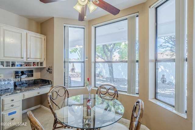 dining room with baseboards, a ceiling fan, and light tile patterned flooring