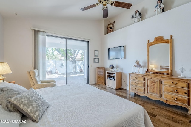 bedroom featuring high vaulted ceiling, access to exterior, a ceiling fan, baseboards, and wood finished floors