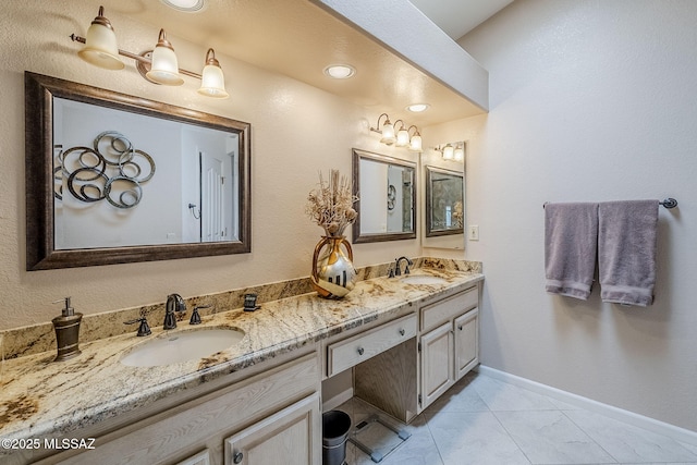 bathroom featuring double vanity, baseboards, a sink, and marble finish floor
