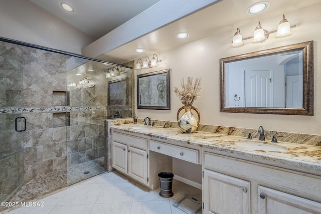full bathroom with double vanity, a sink, a stall shower, and recessed lighting