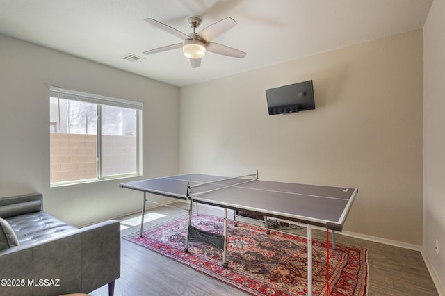 game room with a ceiling fan, baseboards, visible vents, and wood finished floors