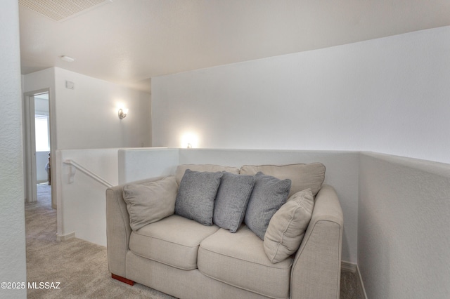 living area featuring visible vents and light carpet