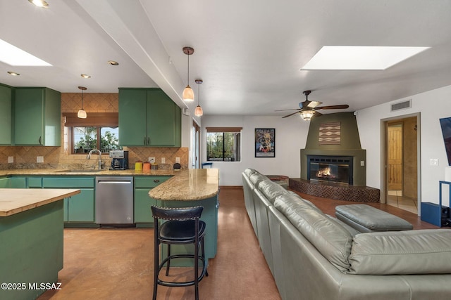 901 W Las Lomitas Rd, Tucson, AZ 85704 - kitchen with green cabinetry, a skylight, open floor plan, and stainless steel dishwasher