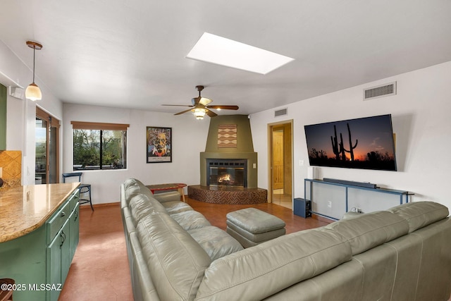 901 W Las Lomitas Rd, Tucson, AZ 85704 - living room featuring a skylight, a ceiling fan, and a large fireplace