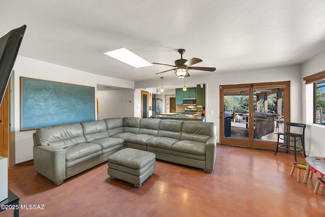 901 W Las Lomitas Rd, Tucson, AZ 85704 - living room featuring a ceiling fan, a skylight, and concrete floors