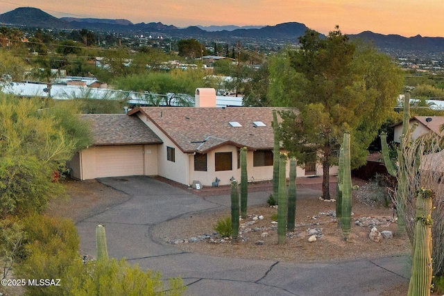 901 W Las Lomitas Rd, Tucson, AZ 85704 - view of front of house with a mountain view, an attached garage, stucco siding, and concrete driveway