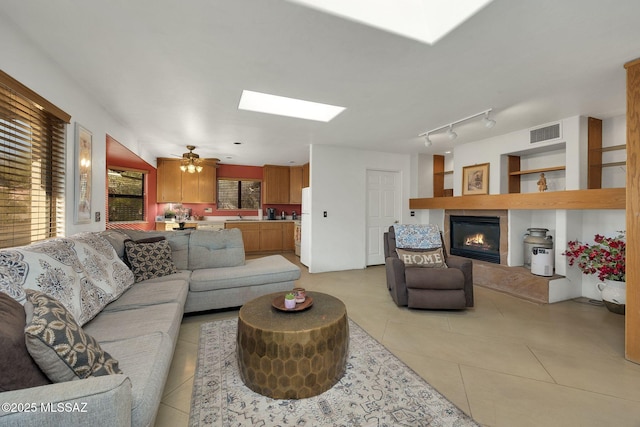 901 W Las Lomitas Rd, Tucson, AZ 85704 - living area featuring a skylight, a glass covered fireplace, and light tile patterned floors
