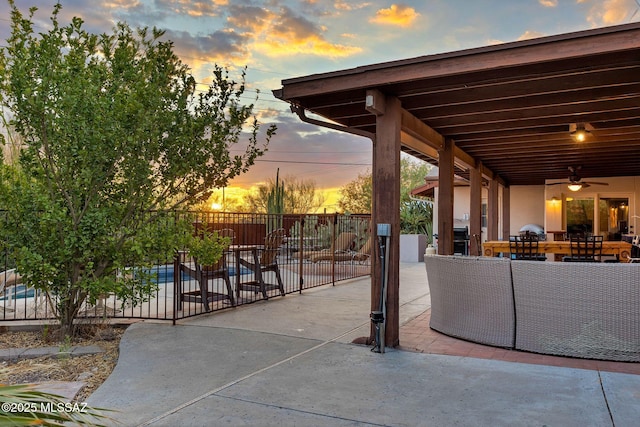 901 W Las Lomitas Rd, Tucson, AZ 85704 - patio terrace at dusk with a patio, a ceiling fan, and outdoor lounge area