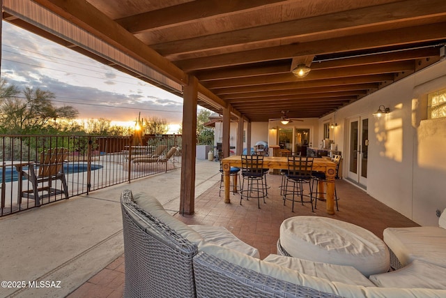 901 W Las Lomitas Rd, Tucson, AZ 85704 - patio terrace at dusk featuring a patio, french doors, ceiling fan, and an outdoor living space