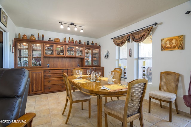 dining area featuring light tile patterned flooring