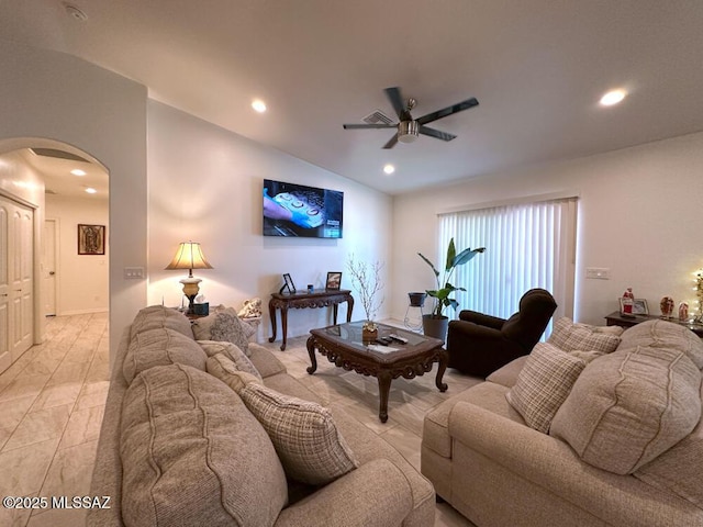 living area with a ceiling fan, arched walkways, and recessed lighting