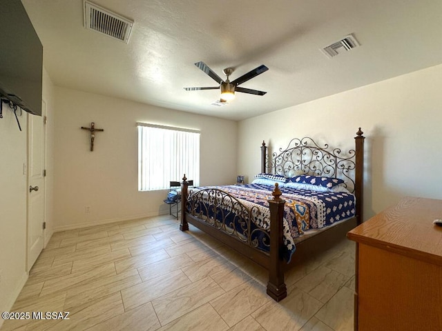 bedroom with visible vents, a ceiling fan, and baseboards