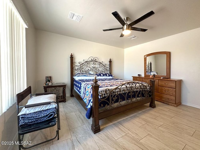 bedroom featuring baseboards, a ceiling fan, and visible vents