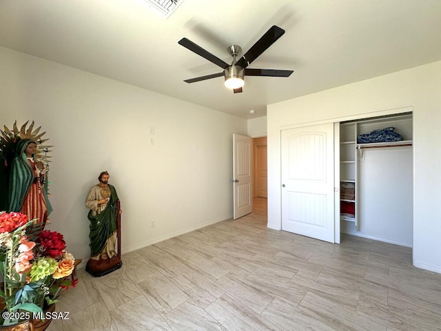 unfurnished bedroom with a closet, baseboards, ceiling fan, and visible vents