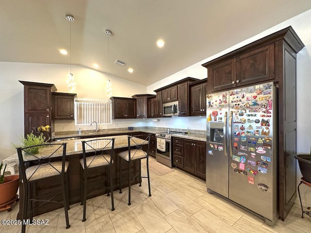 kitchen featuring a sink, a breakfast bar area, dark brown cabinetry, appliances with stainless steel finishes, and visible vents