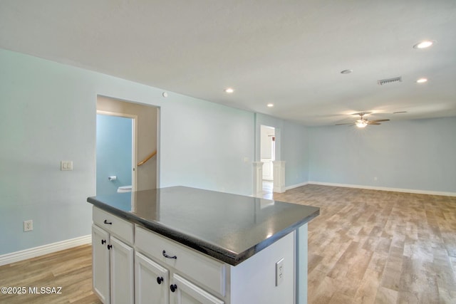 kitchen with recessed lighting, dark countertops, visible vents, a kitchen island, and ceiling fan