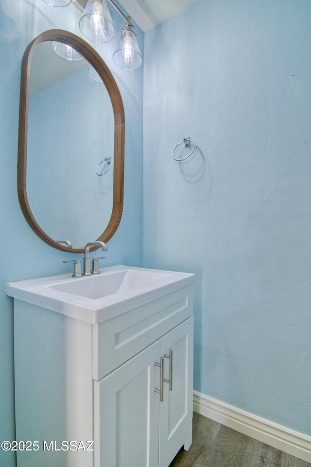 bathroom with baseboards and vanity