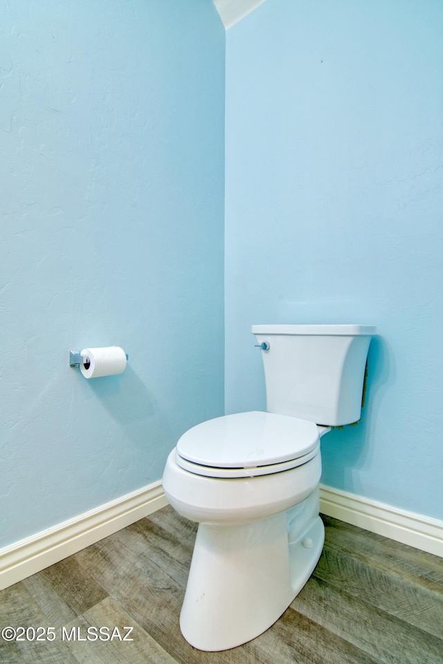 bathroom featuring toilet and baseboards