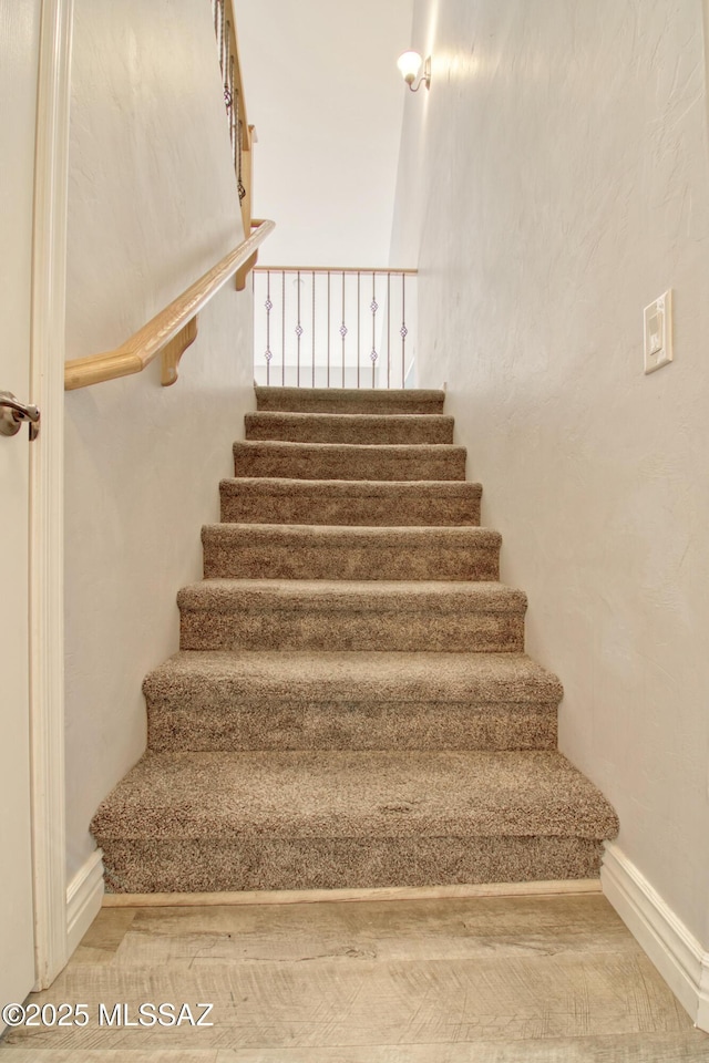 stairway featuring baseboards