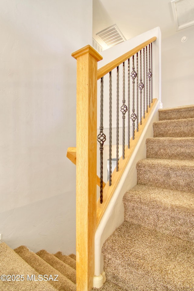 stairway featuring visible vents