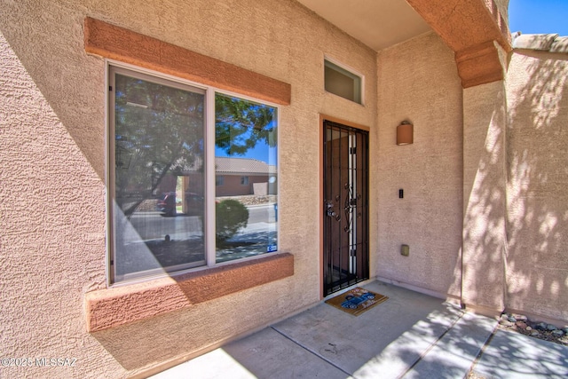 property entrance with stucco siding