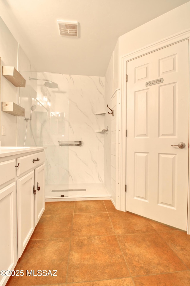 full bathroom with visible vents, tile patterned flooring, vanity, and a marble finish shower