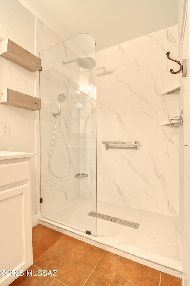 bathroom featuring vanity, tile patterned floors, and a marble finish shower