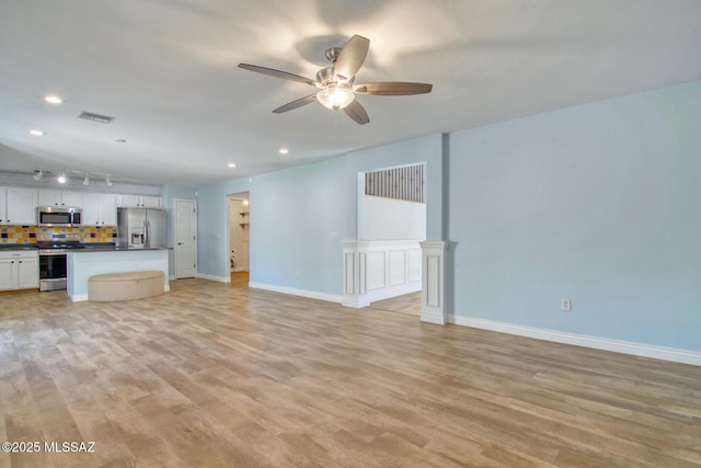 unfurnished living room featuring baseboards, visible vents, recessed lighting, light wood-style floors, and a ceiling fan