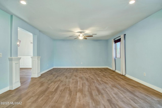 empty room with recessed lighting, light wood-type flooring, a ceiling fan, and baseboards